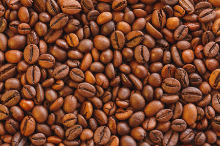 特写烤棕色咖啡豆背景。