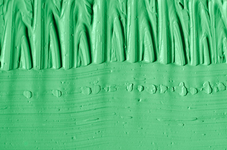绿色化妆品粘土面膜霜体擦洗纹理接近选择性焦点。 用笔画抽象背景。