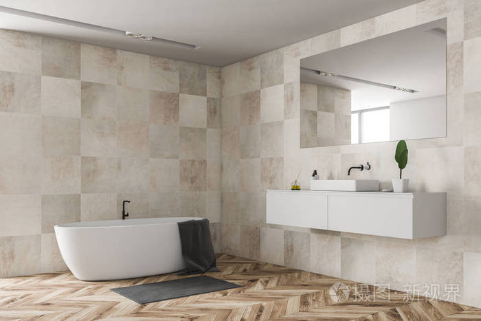 现代浴室的角落,米色瓷砖墙,木制地板,白色水槽站在白色台面上,白色