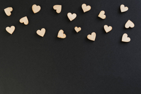 s day black background with a lot of wooden hearts on a chalk bo