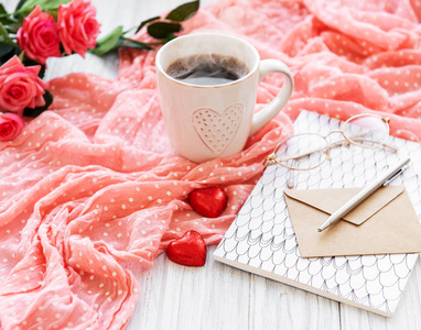 一杯咖啡和巧克力糖果玫瑰和信封