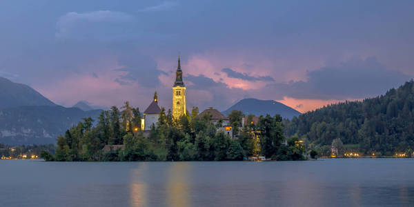 s church and and mountains in backdrop under stormy sky, Sloveni
