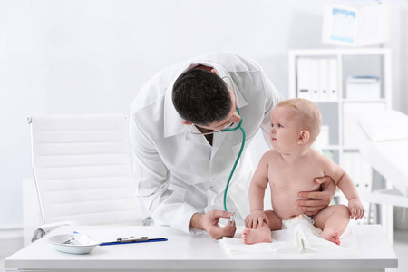 s doctor examining baby with stethoscope in hospital
