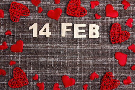 s day background with inscription 14 feb and red hearts on sackc