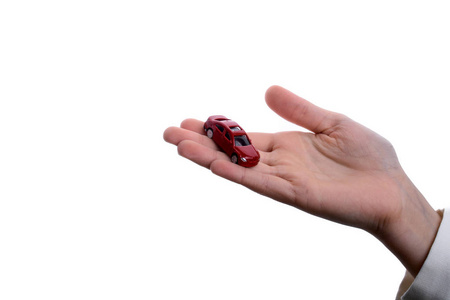 s hand holding a red car on a white background