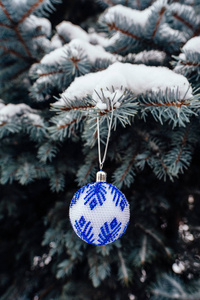 蓝白色圣诞球在杉树枝上靠近