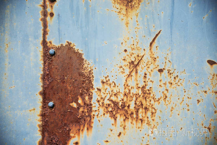 光泽纹理生锈的金属表面覆盖蓝色油漆剥落和开裂纹理接缝和铆钉