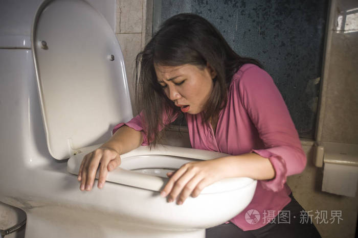 年轻的醉酒或怀孕的亚洲妇女呕吐和呕吐在厕所wc感觉不适和生病,胃痛
