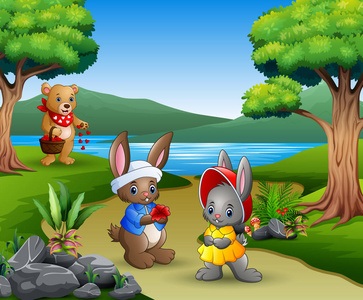卡通夫妇兔子和熊妈妈在公园里照片