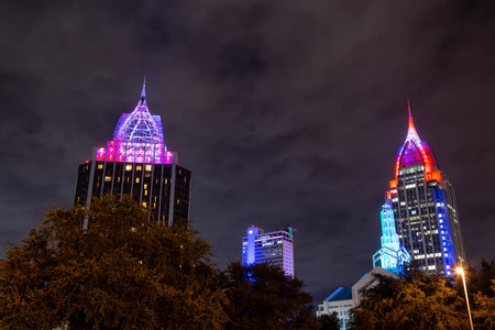 在阴天黑暗的夜晚，市中心的高楼大厦。 拍摄于美国阿拉巴马州移动。