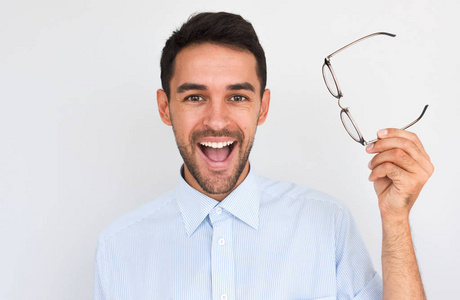 t need glasses anymore, posing against white studio background. 