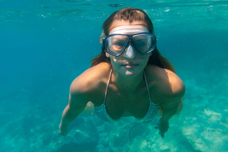 年轻女子在热带海域水下浮潜