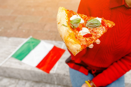 在意大利户外吃披萨的快乐女人。 欧洲旅游和意大利食品概念