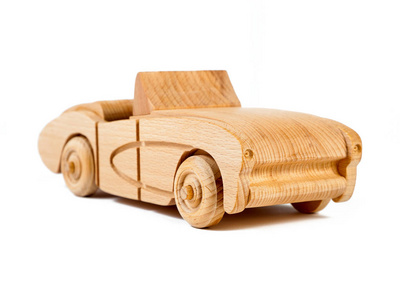 一辆复古车的山毛榉照片。 白色背景上木头做的玩具