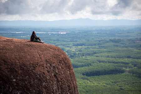 年轻女子坐在泰国福星山顶上图片
