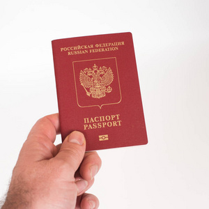 s Hand holding Russian international passport isolated on white 