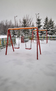 s playground covered with snow in winter