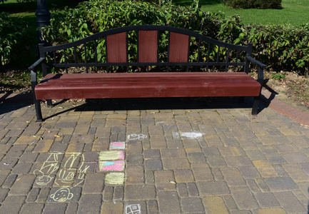 s drawing with chalk on the road.