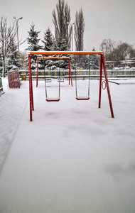 s playground covered with snow in winter