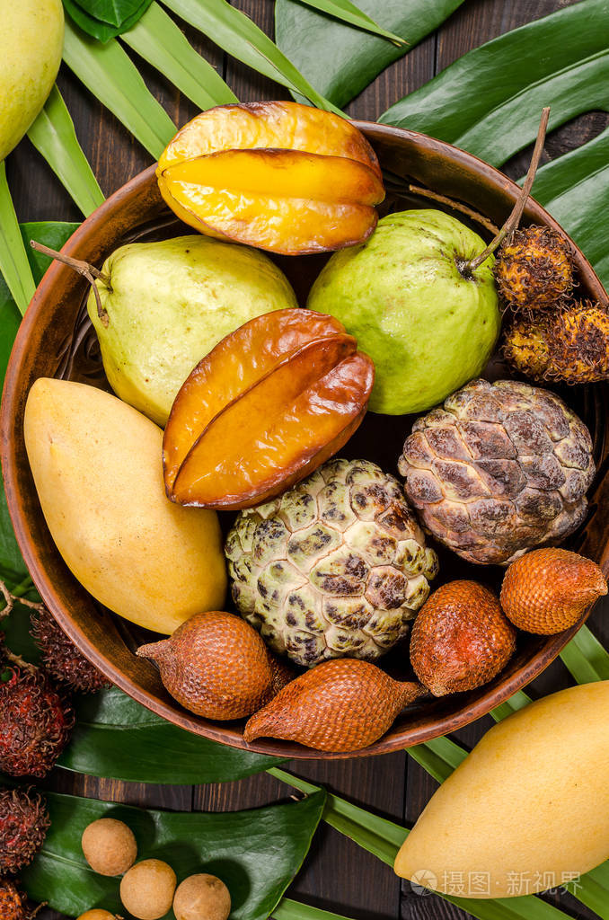 在黑暗的木质乡村背景上的各种泰国热带水果