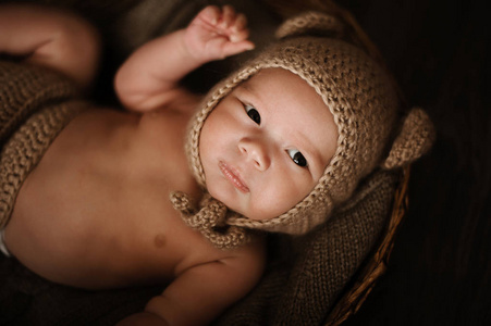 穿针织帽子躺在篮子里的男婴肖像