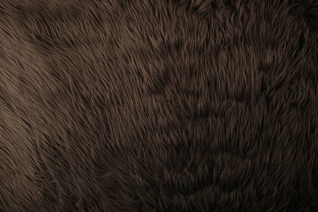 灰色人工毛皮背景。 毛皮织物纹理深色背景。