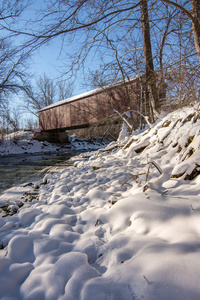 s historical red covered bridge on a snowy sub zero winters day.
