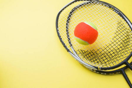 黄色背景下的网球和球拍运动理念