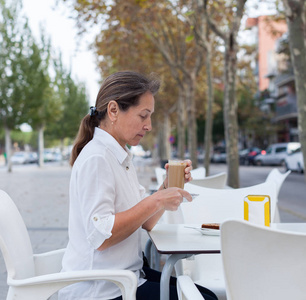 女人在白咖啡桌上喝咖啡。