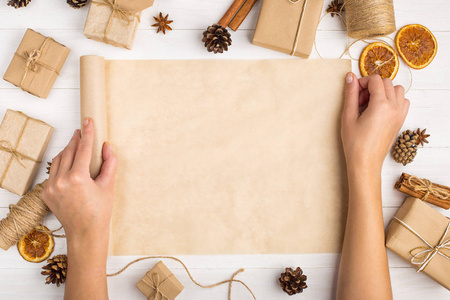 s hands are turning the craft paper roll. Against the background