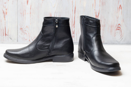 s winter leather boots in black. have toning. closeup.