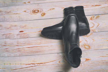 s winter leather boots in black. have toning. closeup.