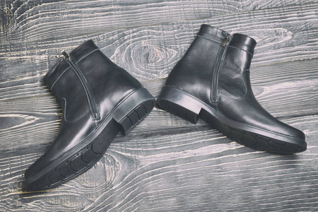 s winter leather boots in black. have toning. closeup.