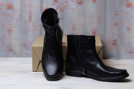 s winter leather boots in black. have toning. closeup.