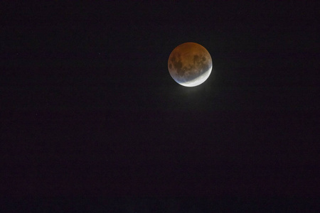 智利圣地亚哥的红月全食从南半球看到地球阴影穿过月球表面并使其变成红色和黄色的惊人天文事件
