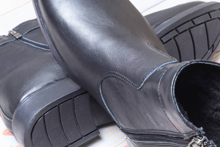 s winter leather boots in black. have toning. closeup.