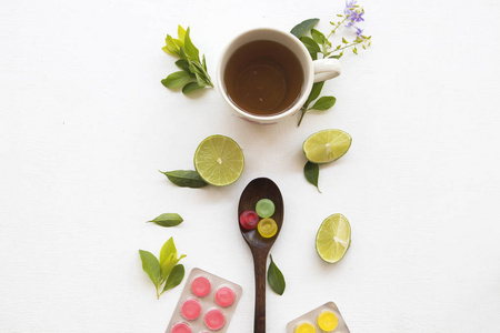 草本蜂蜜柠檬茶健康饮料健康饮料健康护理咽喉痛，菱角和柠檬片与紫色花装饰背景白色