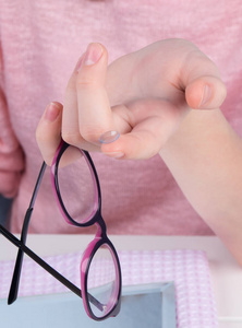 s hand, closeup, with contact lens, to improve vision and glass