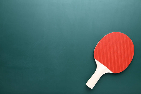 乒乓球拍在绿色背景上照片