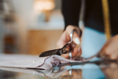 裁缝女人的手在做布料裁剪
