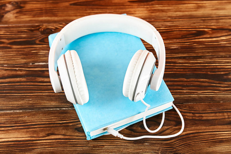  white headphones on table. Old versus new. Close up, copy space