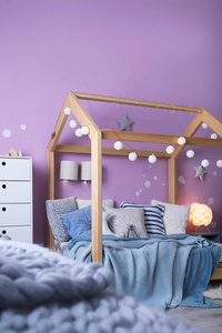 s room interior with comfortable bed and garland