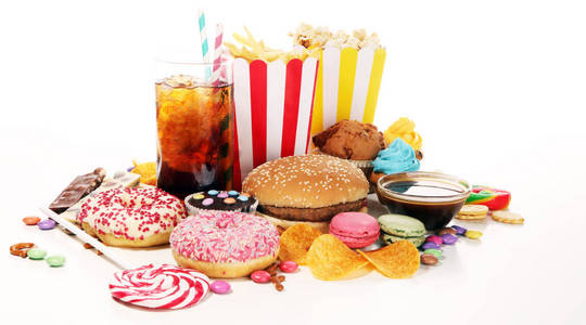 对身材,皮肤,心脏和牙齿有害的食物. 各种快餐碳水化合物食品.照片