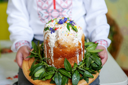 s hands hold decorated Easter cake, closeup. easter concept