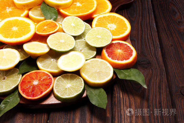 柑橘类水果，带有橙色柠檬葡萄柚和棕色背景的石灰。