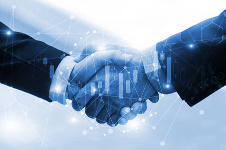 商务人员或投资者握手与股票市场图表和网络连接图表合作商业团队合作