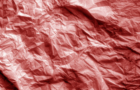 皱巴巴的一张红色的纸。 设计的抽象背景和纹理。