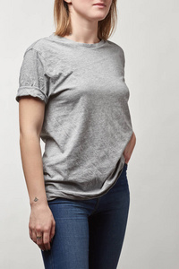 牛仔布和灰色T恤上的年轻女性裁剪的视角，白色上的复制空间被隔离