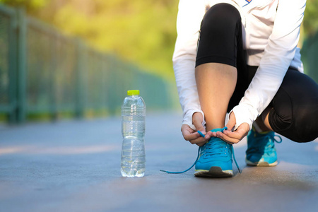 年轻的健身女子在公园户外散步，女跑步者在外面的路上跑步，亚洲运动员在阳光明媚的早晨慢跑和在小径上锻炼。体育健康和健康概念