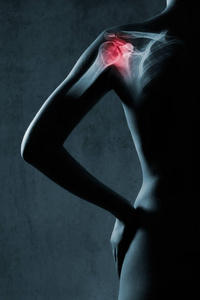 灰色背景下x射线中的人肩关节。 这只手用红色突出显示。